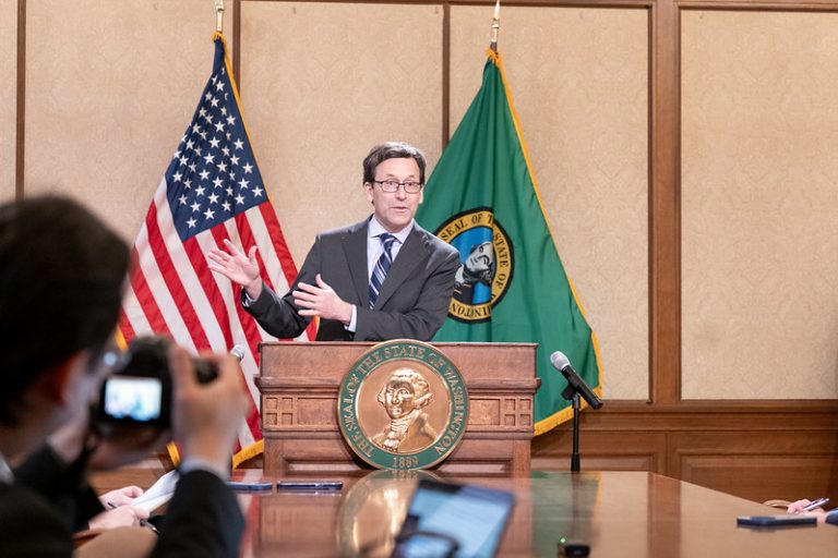 man speaks at podium