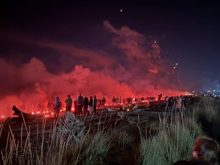 red smoke from flares lights the sky