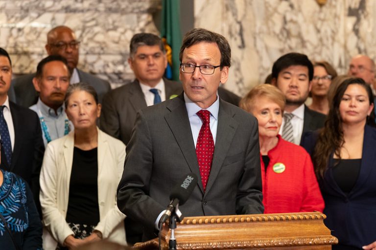 man speaks at podium