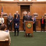 man speaks at podium