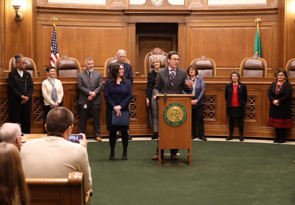 man speaks at podium
