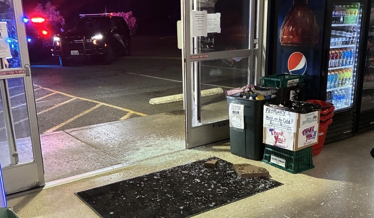Bellingham police patrol vehicle outside CHS Northwest True Value on Meridian Street after burglary suspect broke glass door to enter store.