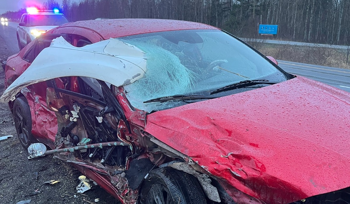 Red car heavily damaged after wrong-way crash on Interstate 5 near Birch Bay in Whatcom County with Washington State Patrol vehicle at the scene.