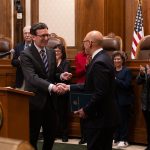 Governor Ferguson shakes hands with Theo Angelis after appointing him to the Washington State Supreme Court