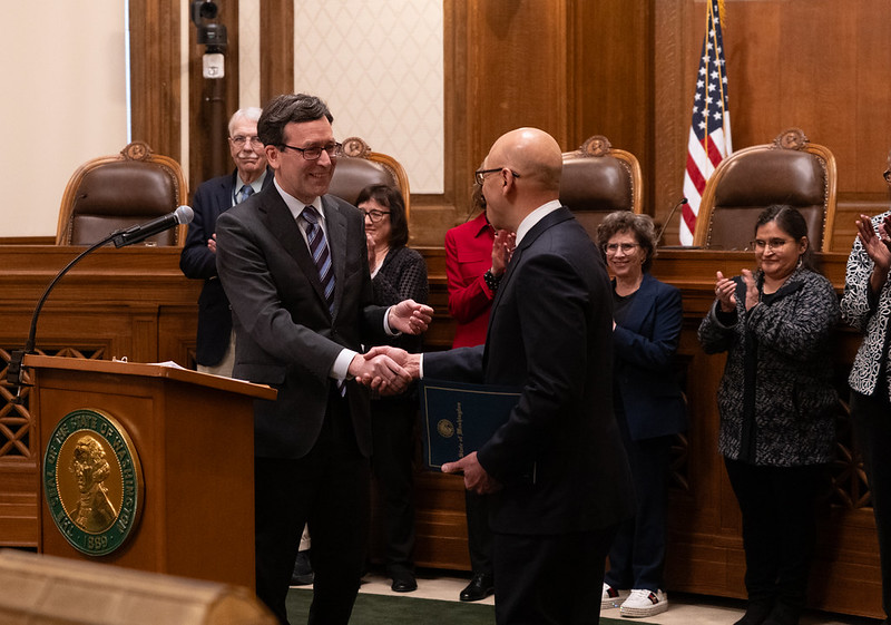 Governor Ferguson shakes hands with Theo Angelis after appointing him to the Washington State Supreme Court