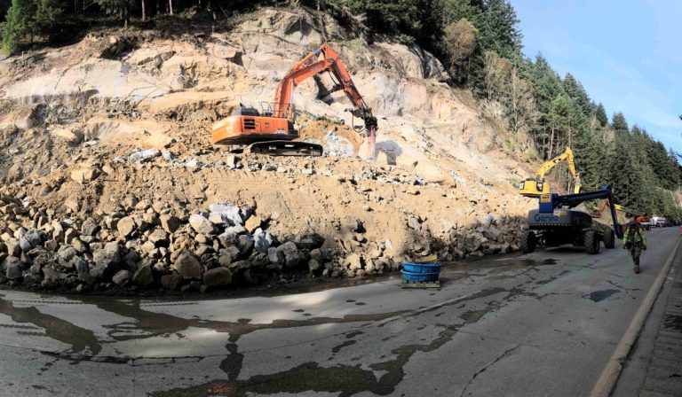 Construction equipment next to rubble as crews work around the clock to reopen I-5