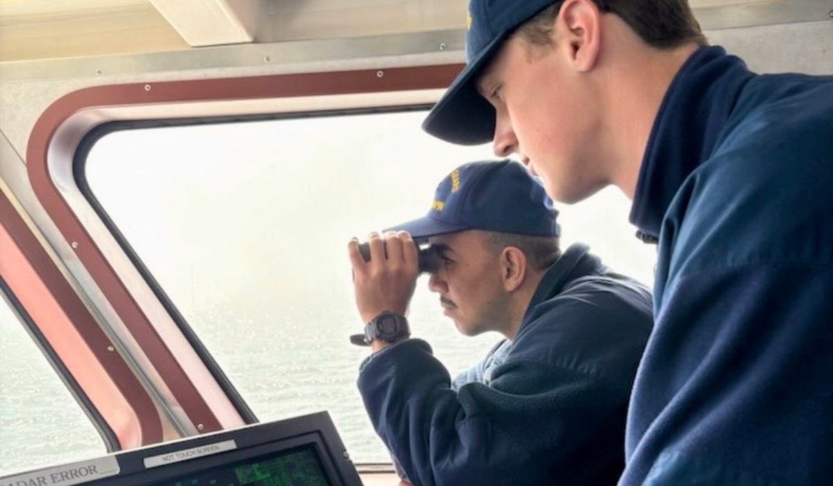 U.S. Coast Guard crew scanning waters during search near Point Wilson