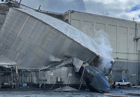Collapsed chemical storage tank at the Nippon Dynawave Packaging mill in Longview following Tuesday’s deadly industrial disaster