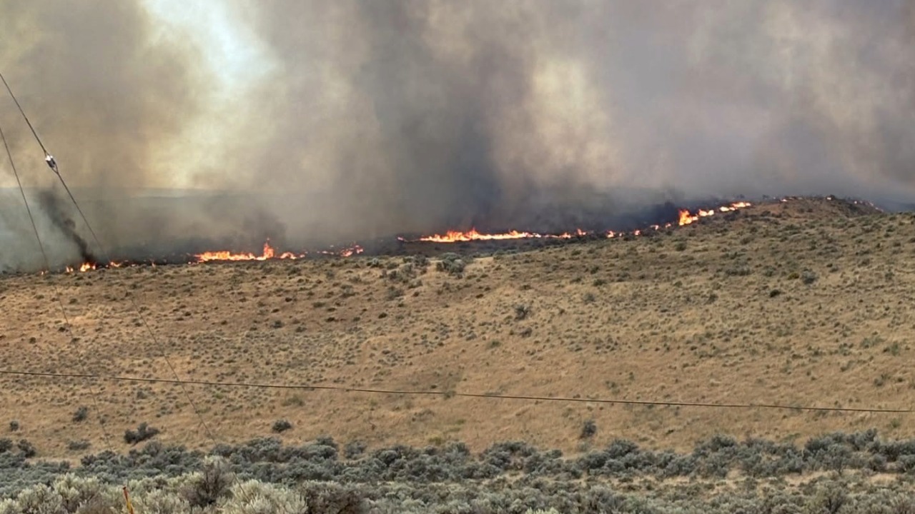 Firefighters continue battling the Garred Road Fire near Sun Lakes and Coulee City on June 23, 2026. The wildfire has grown to 3,346 acres, though evacuation levels were reduced to Level 1 Tuesday afternoon as crews made progress protecting structures and reopening highways.