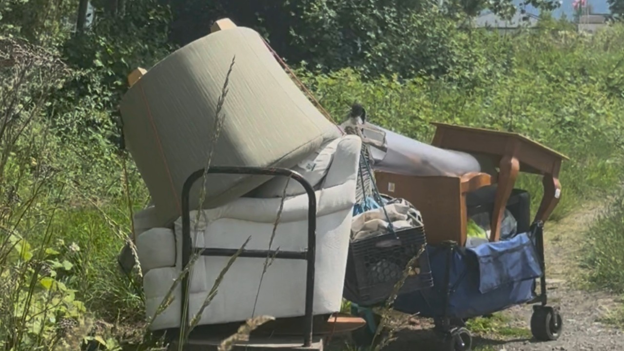 Furniture arrives at the King Mountain encampment Monday as Bellingham officials promise action this summer and cleanup costs continue to climb.