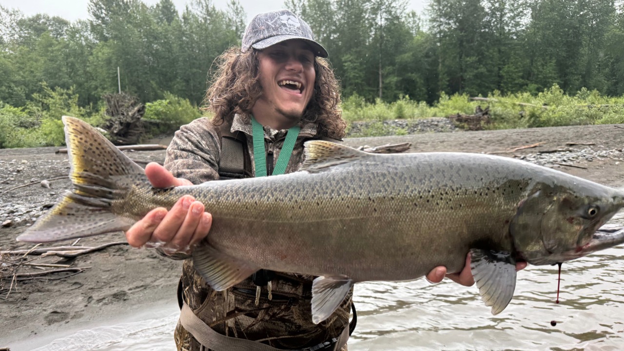 Chris Hamilton holds a buck chinook salmon on Sunday, June 7, 2026.