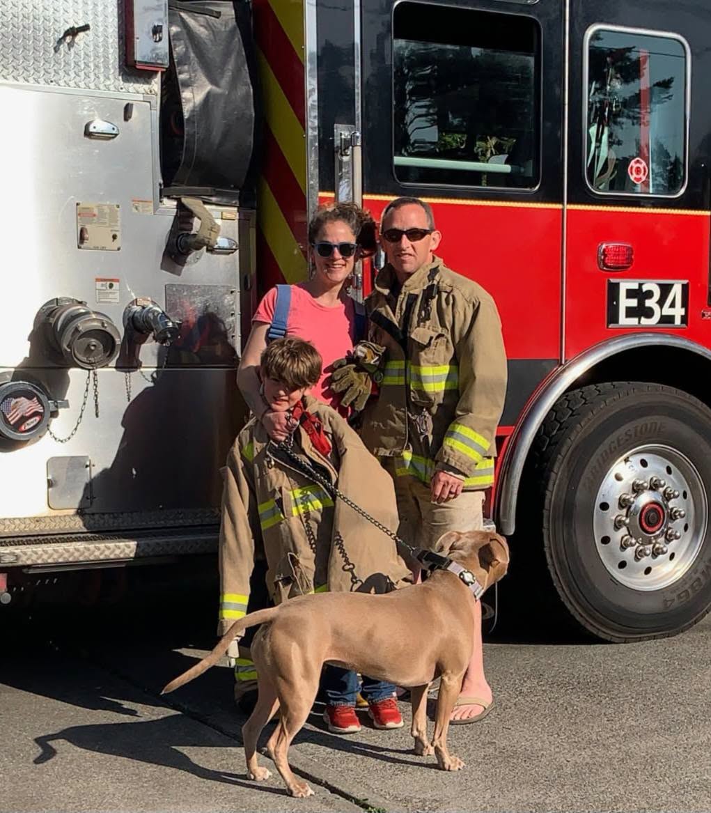 Captain Brian Jones with his family beside Engine 34