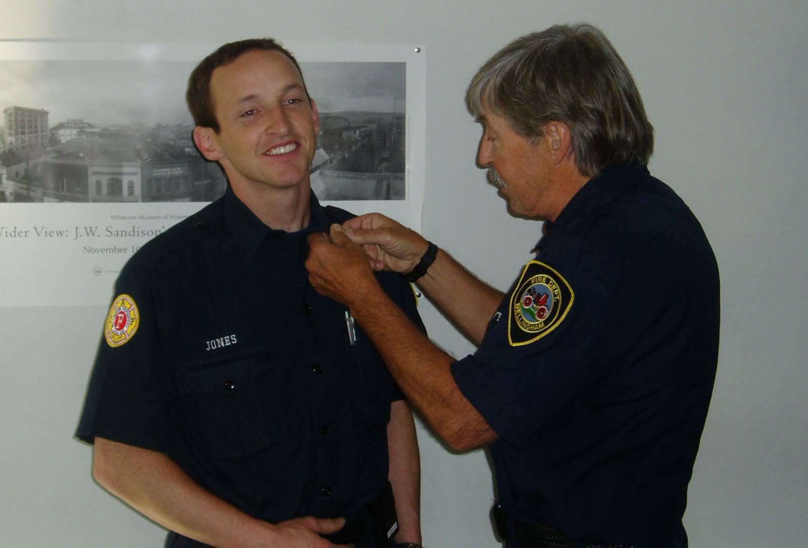 Captain Brian Jones receiving his badge during a pinning ceremony at the Bellingham Fire Department