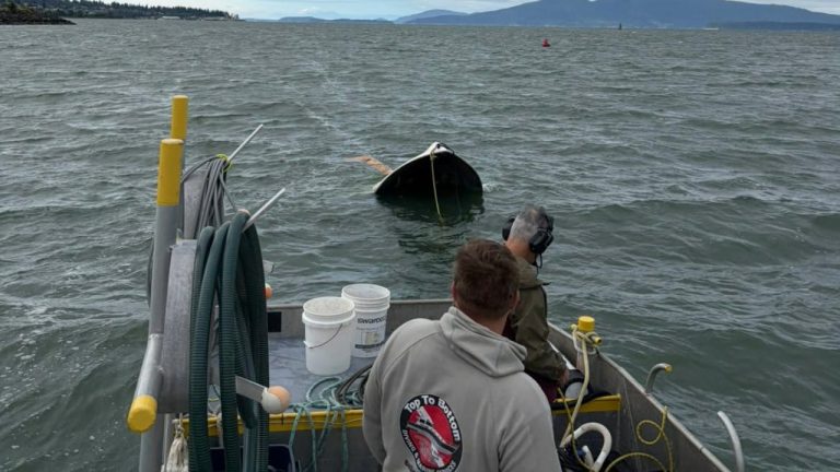 Crews with Top to Bottom Diving and Marine Services prepare to recover the 18-foot powerboat involved in the fatal July 4 capsizing in Bellingham Bay. The vessel was recovered Wednesday as investigators continued working to determine what caused the incident that claimed the life of 49-year-old Kristopher DeBoer.