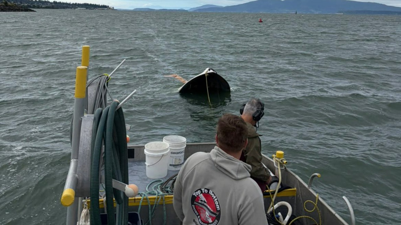 Crews with Top to Bottom Diving and Marine Services prepare to recover the 18-foot powerboat involved in the fatal July 4 capsizing in Bellingham Bay. The vessel was recovered Wednesday as investigators continued working to determine what caused the incident that claimed the life of 49-year-old Kristopher DeBoer.