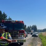 Washington State Patrol and fire crews respond to a two-vehicle injury collision on northbound Interstate 5 near Bow Hill Road on Monday afternoon. Investigators say an improper lane change caused one SUV to roll onto its side, sending one driver to the hospital.