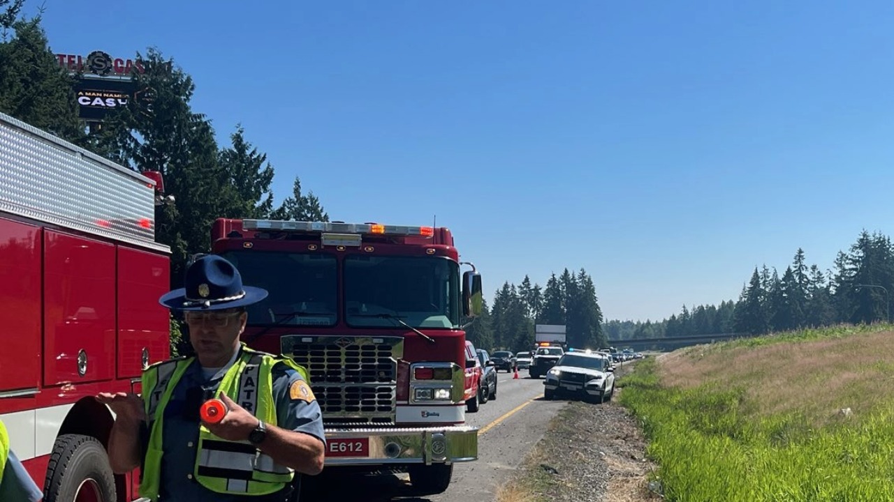 Washington State Patrol and fire crews respond to a two-vehicle injury collision on northbound Interstate 5 near Bow Hill Road on Monday afternoon. Investigators say an improper lane change caused one SUV to roll onto its side, sending one driver to the hospital.