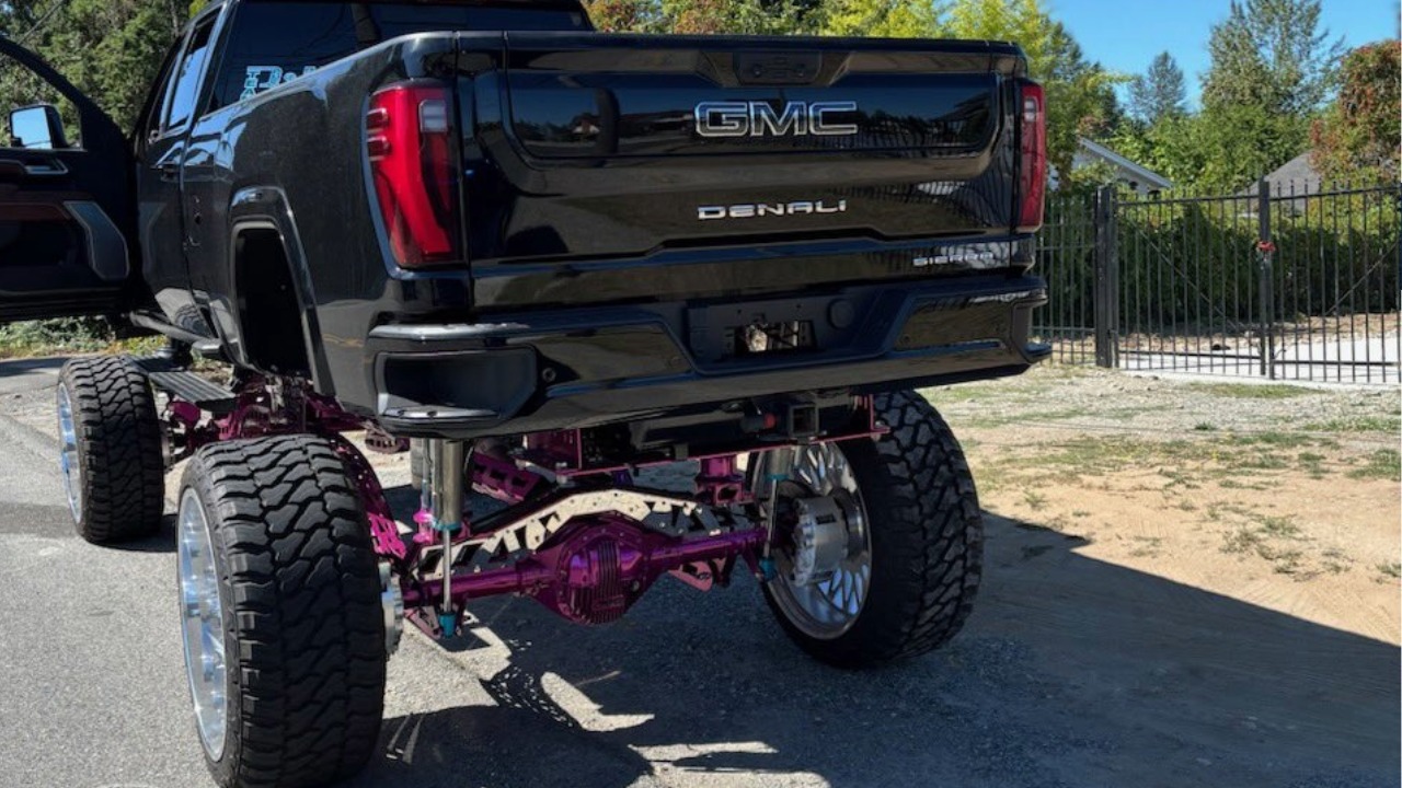 A heavily lifted GMC Denali sits along a Washington roadway after Trooper Southard stopped the driver for what WSP described as numerous equipment violations. Washington regulates bumper height, suspension lifts, tire coverage, mud flaps and lighting on modified vehicles.