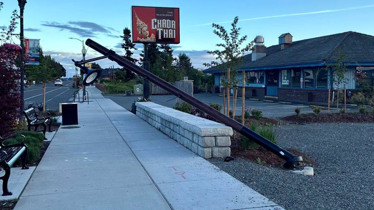 A newly installed light pole leans toward the sidewalk after a gray dually pickup reportedly struck it Tuesday evening near Chada Thai Restaurant at 825 Peace Portal Drive in Blaine. Police are seeking witnesses and information about the driver.