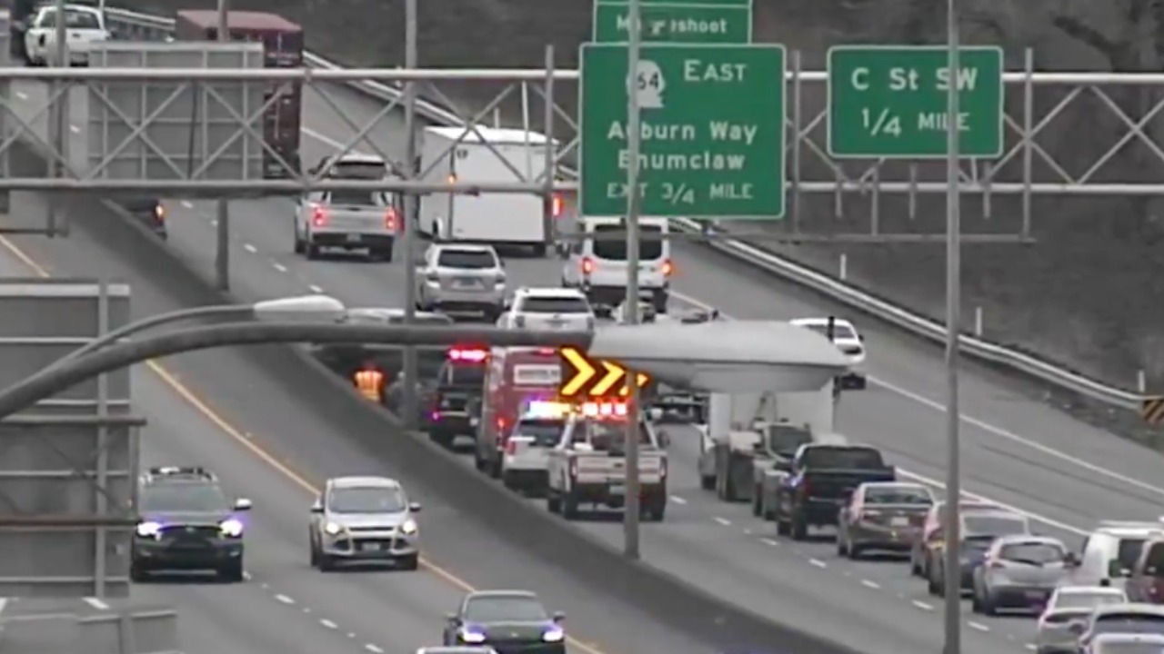 A WSDOT traffic camera shows emergency crews responding to a collision on eastbound SR 18 near C Street SW in Auburn. The image is from a separate incident at the same location.