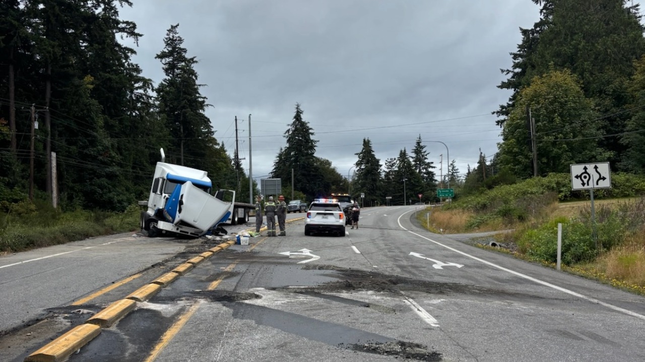 A damaged semi-truck rests against the center median following a two-vehicle injury crash Tuesday on SR 20 near Sharpes Corner. The collision blocked both directions of the highway and forced traffic onto detours.