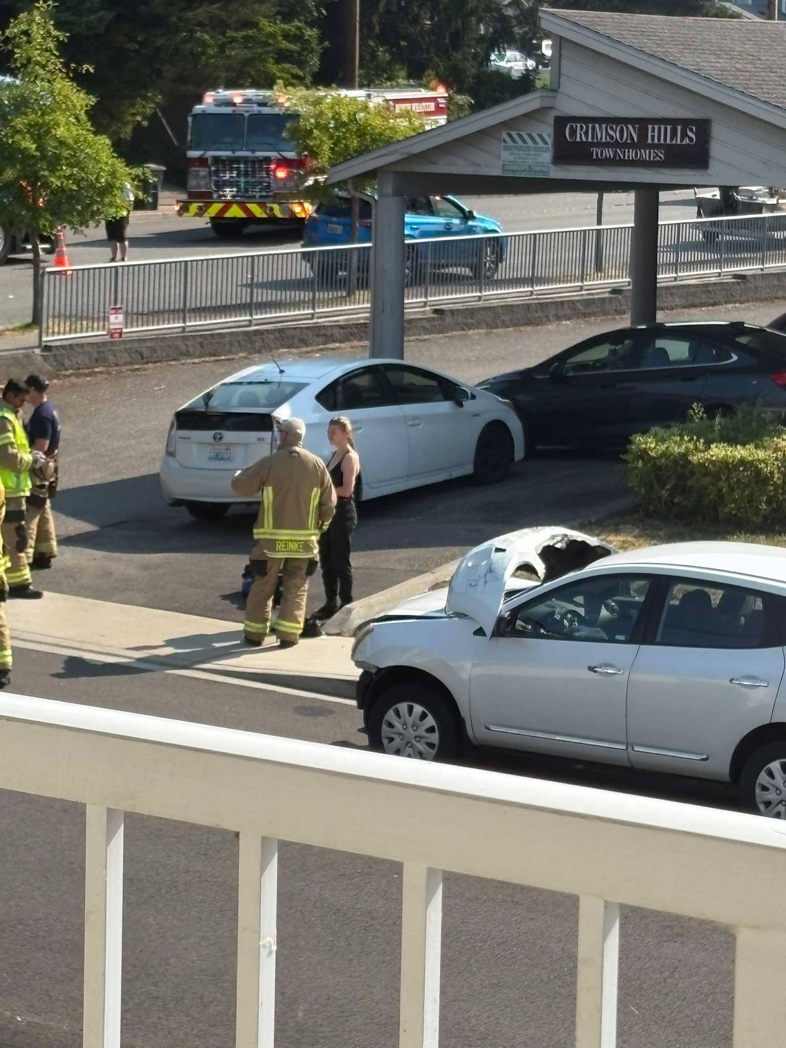 Firefighters and the damaged car at the scene of the Alabama Street crash