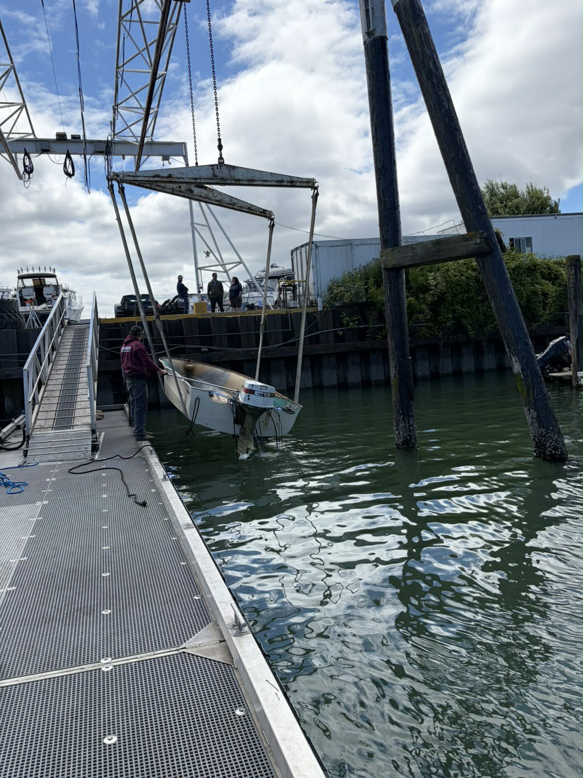 Crane lifting the recovered powerboat from Bellingham Bay