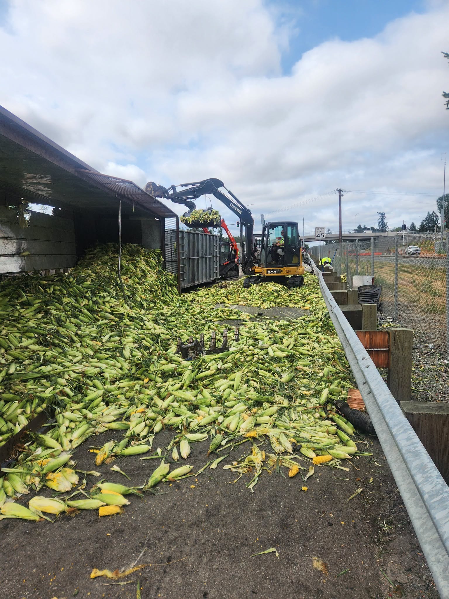 Crews clear a spilled load of corn from the I-5 exit ramp near Thorne Lane