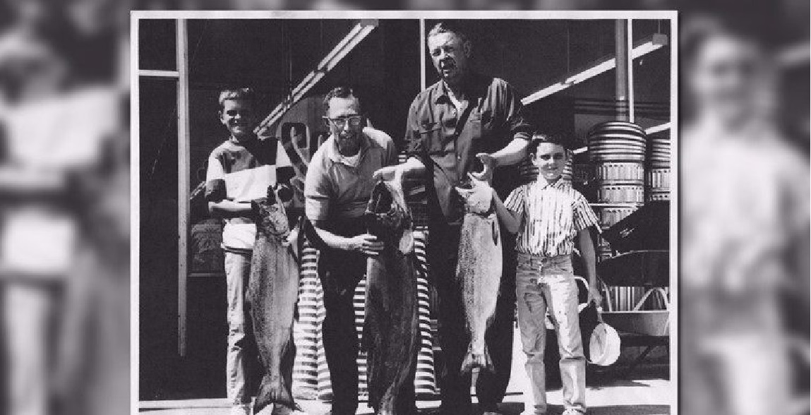 Historical photo of Ira Yeager and family with salmon catch outside the Bellingham store