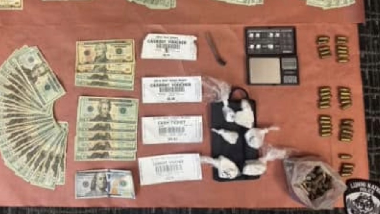 Cash, suspected narcotics, ammunition, a digital scale and other evidence displayed after an Aug. 5 warrant service on Lightning Bird Lane. Photo courtesy of the Lummi Nation Police Department.
