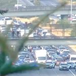 All lanes of I-5 near Everett were briefly closed after a man climbed onto an overpass ledge Friday morning. He was arrested afterward.