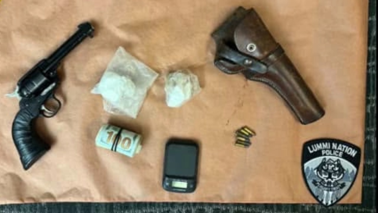 A firearm, ammunition, suspected narcotics, cash and a digital scale confiscated during an Aug. 5 warrant service on Lightning Bird Lane. Photo courtesy of the Lummi Nation Police Department