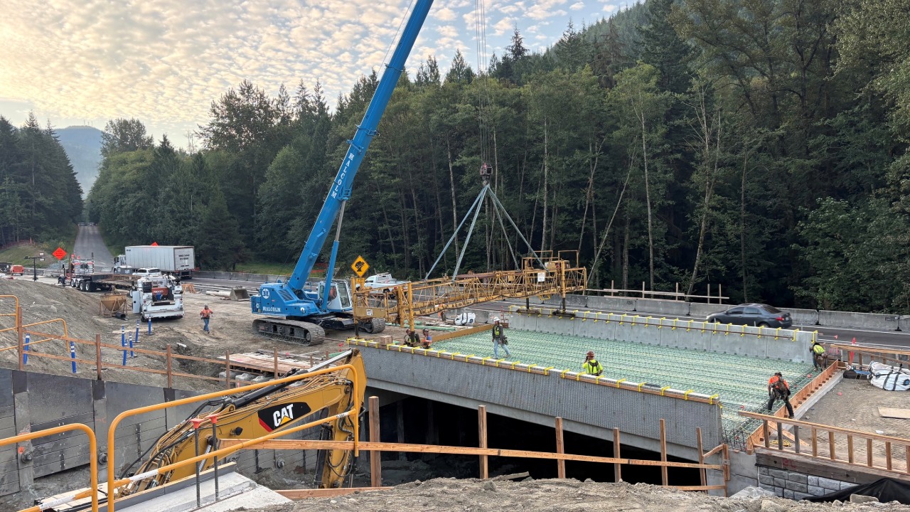 Crews work on the new southbound bridge over Chuckanut Creek while traffic continues through the temporary construction corridor.