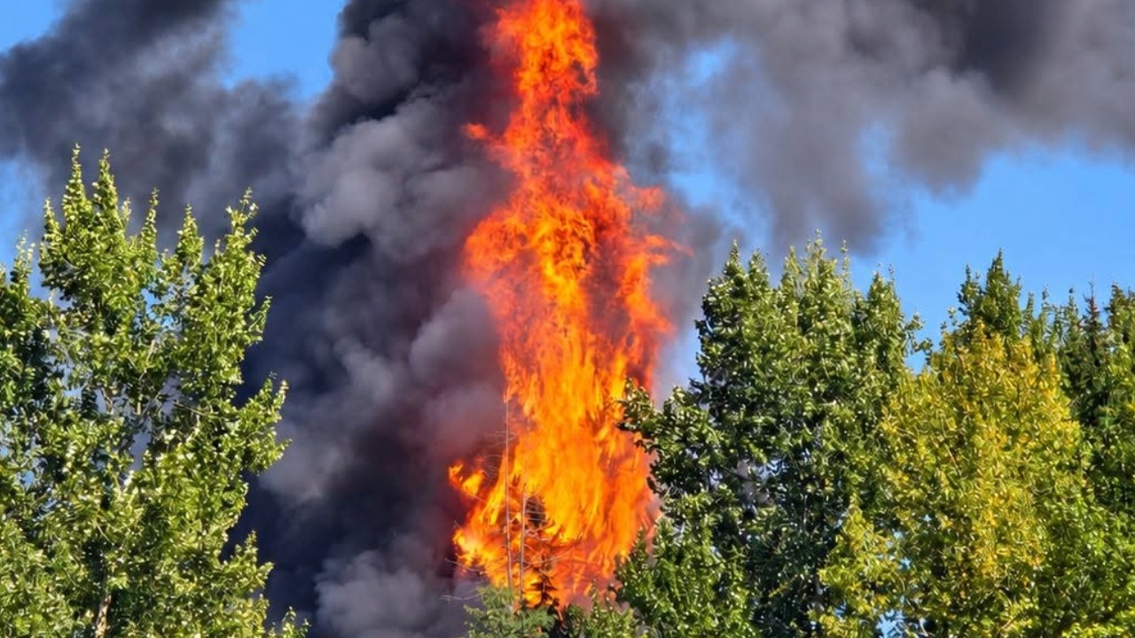 Flames are seen rising above Guide-Meridian on Thursday afternoon as North Whatcom Fire and Rescue and Bellingham Fire Department crews worked to contain the blaze.