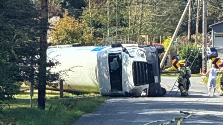 The tanker truck lies on its side on Taylor Street as Bellingham firefighters respond to the scene.