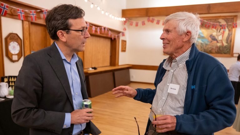 Gov. Bob Ferguson speaks with Mike Hyde at the At-Sea Processors Association's fall breakfast in Seattle.