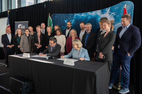 Gov. Bob Ferguson and Danish Deputy Chief of Mission Karen Eva Abrahamsen sign a memorandum of understanding to expand cooperation between Washington state and Denmark during One Ocean Week in Seattle. The agreement focuses on maritime decarbonization, port development, sustainable fuels and industrial innovation.