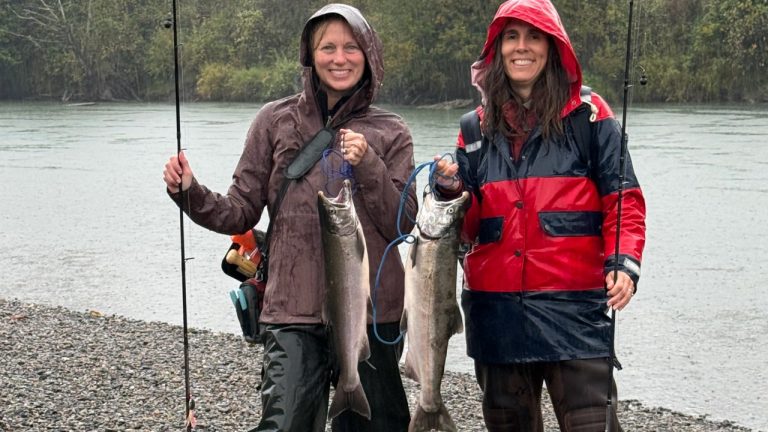 Robin Sheehy, left, and Rebecca Mashhadian show off their coho catches on a September rainy day along one of Washington's salmon rivers.