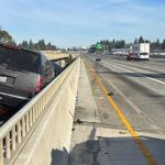 A GMC Yukon sits in the median and a 20-year-old Tacoma motorcyclist faces a reckless driving charge after a three-vehicle crash on I-5 near SR 516 in Kent on Friday morning.